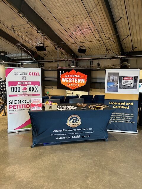 Altura Environmental Services booth with a branded table at a community event